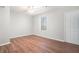 Clean and spacious bedroom with hardwood floors, a ceiling fan, and a window offering natural light at 3448 Great Meadows Ct, Lithonia, GA 30038