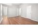Open, airy bedroom featuring sleek hardwood floors and neutral wall color, offering endless design possibilities at 3448 Great Meadows Ct, Lithonia, GA 30038
