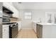 Modern kitchen boasts stainless steel appliances, white cabinets, and ample counter space for cooking and entertaining at 3448 Great Meadows Ct, Lithonia, GA 30038
