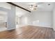 Open-concept living room featuring high ceilings with wood beams and hardwood floors, perfect for entertaining at 3448 Great Meadows Ct, Lithonia, GA 30038