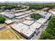 Overhead view of commercial properties including businesses, apartments, and roadways surrounded by trees at 913 Spencer Ave, Atlanta, GA 30318