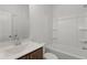 Bathroom featuring a wood vanity, tub, and shower combination at 913 Spencer Ave, Atlanta, GA 30318