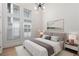 Bright main bedroom features large windows and a modern chandelier at 913 Spencer Ave, Atlanta, GA 30318