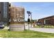 Community entrance with modern art installation, signage, and landscaping at 913 Spencer Ave, Atlanta, GA 30318