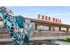 Exterior view of a vibrant food hall with eye-catching signage and decorative elements at 913 Spencer Ave, Atlanta, GA 30318