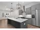 Modern kitchen boasts gray cabinets, stainless steel appliances, and a large island with seating at 913 Spencer Ave, Atlanta, GA 30318