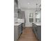 A kitchen showcases gray cabinets, stainless steel appliances, and an island with a built-in microwave at 913 Spencer Ave, Atlanta, GA 30318