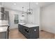 Featuring gray cabinets, stainless steel appliances, and a spacious island with quartz countertops at 913 Spencer Ave, Atlanta, GA 30318