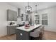 Modern kitchen with stainless steel appliances, a center island with bar seating, and stylish pendant lighting at 913 Spencer Ave, Atlanta, GA 30318