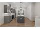 Modern kitchen boasts gray cabinets, stainless steel appliances, and an island with pendant lighting at 913 Spencer Ave, Atlanta, GA 30318