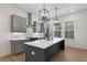The kitchen features gray cabinets, stainless steel appliances, and a spacious island with quartz countertops at 913 Spencer Ave, Atlanta, GA 30318