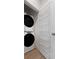 Convenient laundry area with a stacked washer and dryer and practical storage with wire basket shelving at 913 Spencer Ave, Atlanta, GA 30318