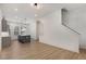 Bright open floor plan showcasing the kitchen with pendant lights and hardwood floors flowing into the living area with stairs at 913 Spencer Ave, Atlanta, GA 30318