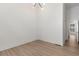 Bright, minimalist living room with wood floors and modern lighting fixture at 913 Spencer Ave, Atlanta, GA 30318