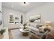 Bright living area boasting hardwood floors, a comfortable sectional sofa, a marble coffee table, and ample natural light at 913 Spencer Ave, Atlanta, GA 30318