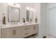 Bright bathroom featuring double vanity with bronze hardware, quartz countertop, and neutral walls at 1300 Memorial Se Dr # 12, Atlanta, GA 30317