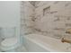 Bathroom features include tub, toilet and marble-look tile at 1300 Memorial Se Dr # 12, Atlanta, GA 30317