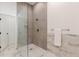 Modern tiled shower with glass enclosure, bronze hardware, tile flooring, and neutral walls at 1300 Memorial Se Dr # 12, Atlanta, GA 30317