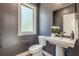 Elegant powder room features dark walls, pedestal sink, and a decorative mirror at 1300 Memorial Se Dr # 12, Atlanta, GA 30317