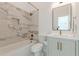 Bathroom featuring marble tile shower, and bronze hardware, with vanity and mirror at 1300 Memorial Se Dr # 12, Atlanta, GA 30317