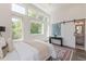 Bedroom featuring hardwood floors, multiple windows, and a sliding barn door leading to the en suite at 1300 Memorial Se Dr # 12, Atlanta, GA 30317