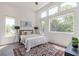 Bright bedroom with high ceilings, hardwood floors, a large window, and an area rug at 1300 Memorial Se Dr # 12, Atlanta, GA 30317