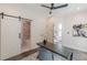 Comfortable office features a ceiling fan, hardwood floors, barn door to bathroom and modern desk at 1300 Memorial Se Dr # 12, Atlanta, GA 30317