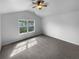Spacious carpeted bedroom with a large window and ceiling fan at 148 Hill Side Way, Hiram, GA 30141