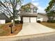 Two-story home features a brick facade, two-car garage, landscaped yard, and a concrete driveway at 148 Hill Side Way, Hiram, GA 30141