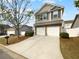 Charming two-story home featuring a two-car garage, stone accents, and professionally landscaped yard at 148 Hill Side Way, Hiram, GA 30141