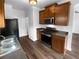 Well-lit kitchen features stainless steel appliances, granite countertops, and wood look flooring at 148 Hill Side Way, Hiram, GA 30141