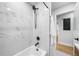 Bright bathroom with black shower, marble, new paint, and hardwood floors at 2781 Long Way, Decatur, GA 30032