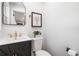 Modern powder room with sleek black vanity, gold fixtures, and stylish decor at 2781 Long Way, Decatur, GA 30032