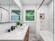 Bright bathroom with white bathtub, glass, view, and vanity at 2781 Long Way, Decatur, GA 30032