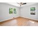 Bright bedroom with a modern ceiling fan, light walls, and hardwood floors with a view at 2781 Long Way, Decatur, GA 30032