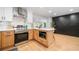 Eat-in kitchen with a stainless steel stove, microwave, island, and unique accent wall at 2781 Long Way, Decatur, GA 30032