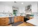 Bright kitchen with white upper cabinets and stainless steel appliances with a window at 2781 Long Way, Decatur, GA 30032