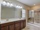 Bathroom with a glass-enclosed shower, tile floors, and a double vanity at 4321 Lanier Ridge Walk # 1704, Cumming, GA 30041