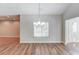 Dining area with hardwood floors, a chandelier, and bright, natural light at 4321 Lanier Ridge Walk # 1704, Cumming, GA 30041