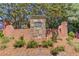 Stone entrance marker for Brookhaven At Lanier Ridge surrounded by lush greenery and foliage at 4321 Lanier Ridge Walk # 1704, Cumming, GA 30041