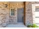 Close up of the front door and exterior brickwork at 4321 Lanier Ridge Walk # 1704, Cumming, GA 30041