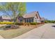 Charming brick home featuring a well-manicured lawn, mature tree, colorful shrubs and an inviting driveway at 4321 Lanier Ridge Walk # 1704, Cumming, GA 30041