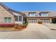 Exterior view showcasing a brick home with a two-car garage and attractive landscaping at 4321 Lanier Ridge Walk # 1704, Cumming, GA 30041