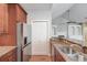 Kitchen with stainless steel appliances and wood cabinets with granite countertops at 4321 Lanier Ridge Walk # 1704, Cumming, GA 30041