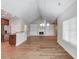 Open-concept living room featuring hardwood floors, built-in bookcases, and a fireplace at 4321 Lanier Ridge Walk # 1704, Cumming, GA 30041