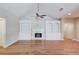 Spacious living room with hardwood floors, built-in shelves and cabinets, and a fireplace at 4321 Lanier Ridge Walk # 1704, Cumming, GA 30041