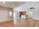 Bright open-plan living space showing hardwood floors, vaulted ceilings, kitchen, and entry at 4321 Lanier Ridge Walk # 1704, Cumming, GA 30041