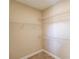 Walk-in closet with ample storage space thanks to installed shelving and neutral carpet at 4321 Lanier Ridge Walk # 1704, Cumming, GA 30041