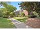 Brick apartment buildings featuring walkways with manicured lawns at 55 Delmont Ne Dr # D1, Atlanta, GA 30305
