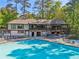 Community pool and clubhouse surrounded by lush trees at 55 Delmont Ne Dr # D1, Atlanta, GA 30305